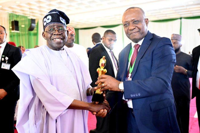 President Bola Ahmed Tinubu receiving a plaque from President of Nigerian Guild of Editors, Eze Anaba, at the All Nigeria 21st Nigerian Guild of Editors’ Annual Conference, at the State House Conference Centre, Abuja. Wednesday, November 12, 2025