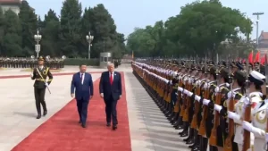President Donald Trump inspecting a military guard during the official ceremony.