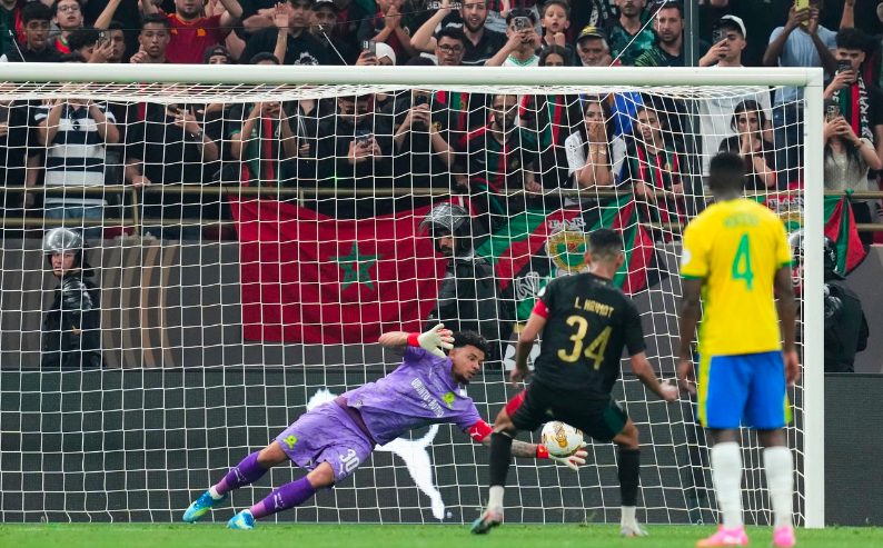 Mamelodi Sundowns’ goalkeeper Ronwen Williams, dives to save a penalty kick by AS FAR Rabat’s captain Mohamed Hrimat.