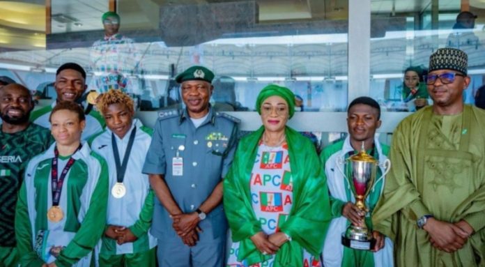Nigeria's championship-winning wrestling team with First lady Sen. Remi Tinubu (C), National Sports Commission Chairman, Shehu Dikko (R) and Nigeria Wrestling Federation president and Customs boss, Bashir Adewale Adeniyi.