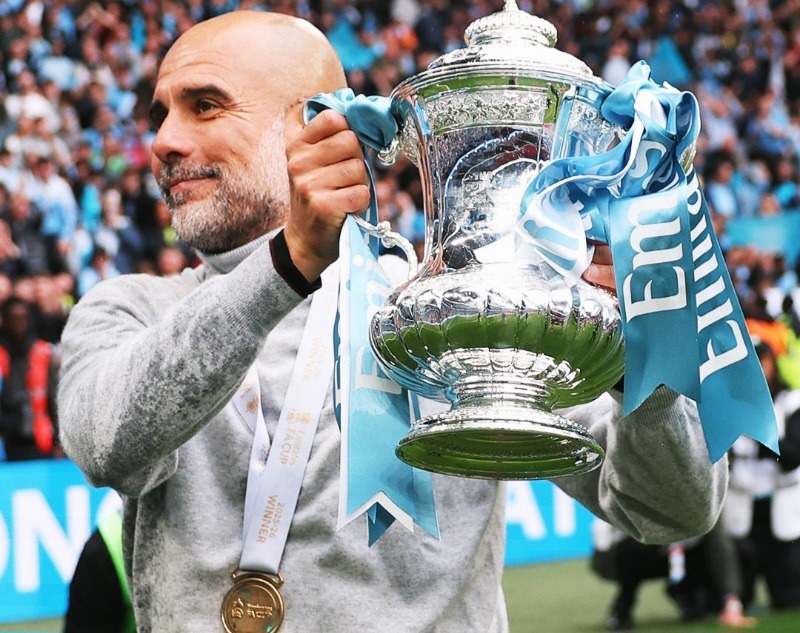 Manchester City manager, Pep Guardiola, with FA Cup trophy.