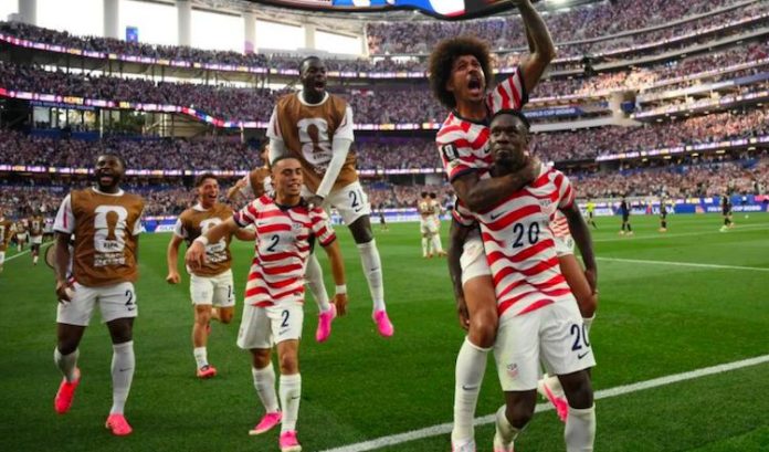 United States striker Folarin Balogun celebrates goal against Paraguay with teammates during 2026 FIFA World Cup encounter.