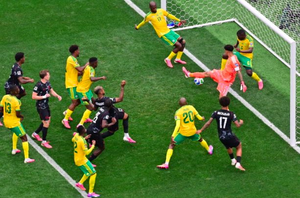 Canada’s Moise Bombito heads the ball but is denied by South Africa's Aubrey Modiba.
