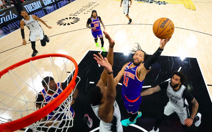 New York Knicks guard Jalen Brunson (11) drives to the basket past San Antonio Spurs forward Julian Champagnie