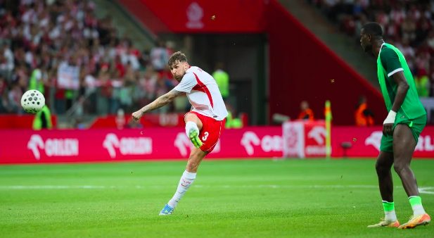 Poland's Przemyslaw Wisniewski scores goal against Nigeria.