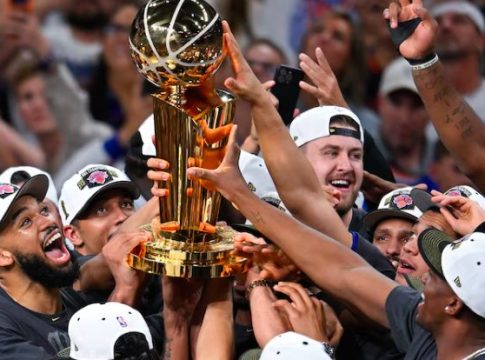 The New York Knicks celebrate with the NBA Championship Trophy.