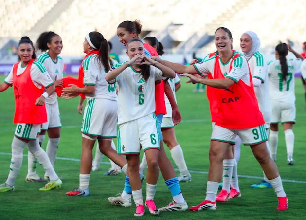 Algeria's senior women's football team players celebrate goal.