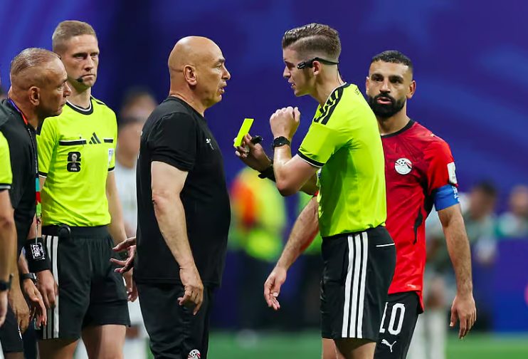 Egypt head coach Coach Hossam Hassan with referee.