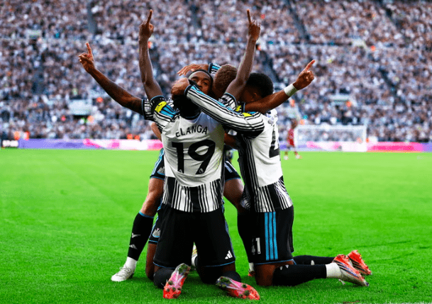 Newcastle's Joe Willock celebrates goal with teammates.